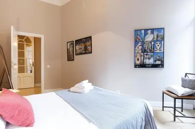 a bedroom with a bed and pictures on the wall at AinB B&B Born-Via Laietana in Barcelona