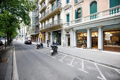 two motorcycles parked on the side of a city street at Stay U-nique Apartments Rambla Catalunya VI in Barcelona