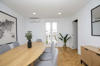 a dining room with a wooden table and chairs at Stay U-nique Apartments Rambla Catalunya VI in Barcelona