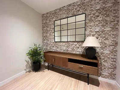 a living room with a brick wall and a lamp at Stay U-nique Apartment Muntaner in Barcelona