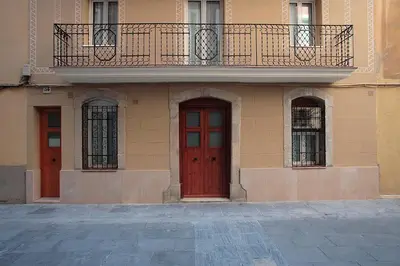 a building with two red doors and a balcony at ClassBedroom Barcelona Beach Apartments in Barcelona