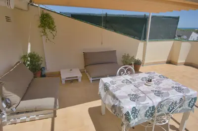 a patio with a table and a couch at Apartamento Sunny Home in Cunit