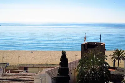 a view of the beach and the ocean from a building at OASIS BEACH-CITY apartment in Montgat