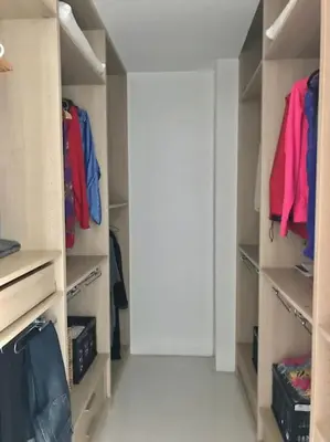 a walk in closet with open shelves and a door at Sitges espectacular vista al mar in Sant Pere de Ribes