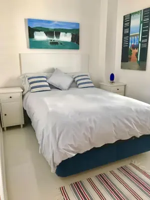 a bedroom with a large bed with two pillows at Sitges espectacular vista al mar in Sant Pere de Ribes