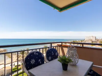 a table and chairs on a balcony with the beach at Apartment Garbi by Interhome in Cunit