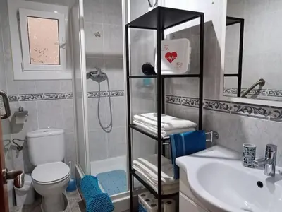 a bathroom with a shower and a toilet and a sink at GARDEN'S SEA PiNEDA DE MAR in Pineda de Mar