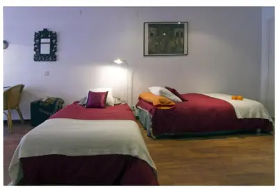 two beds sitting next to each other in a room at Migjorn Apartment a place in the heart of Sitges in Sitges