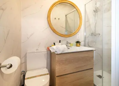 a bathroom with a toilet and a mirror at Charming Seaside Apartment in Barceloneta, Renovated with Stunning Sea Views in Barcelona