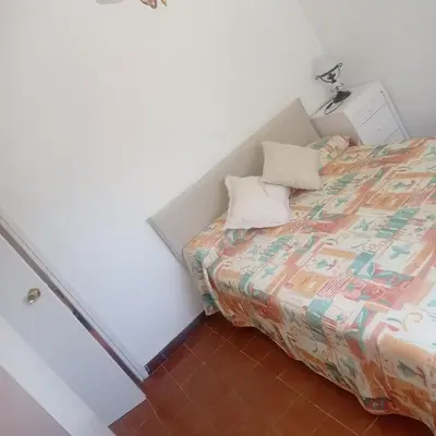 a small bedroom with a bed with two pillows at Ca La Montserrat - Wine Rural House in San Martín Sarroca