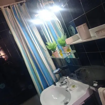 a bathroom with a sink and a shower curtain at Ca La Montserrat - Wine Rural House in San Martín Sarroca