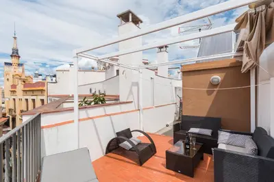 a balcony with a view of the eiffel tower at Apartamentos Mayor by Habama Group in Sitges