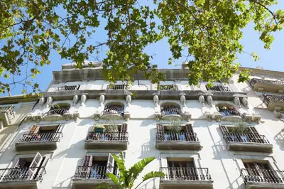 a white building with balconies and windows at 