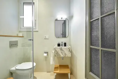 a bathroom with a toilet and a sink and a mirror at 