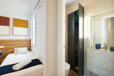 a bedroom with a bed and a bathroom with a sink at 