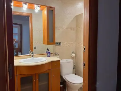 a bathroom with a toilet and a sink and a mirror at Opening Doors Premiá Beach - Sol & playa cerca Barcelona in Premiá de Mar