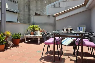 a table and chairs on a patio with plants at Penthouse 100m from Sea with Terrace, Near BCN in Mataró