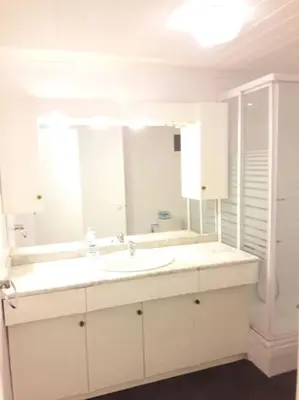 a white bathroom with a sink and a mirror at HABITACIÓN DOBLE, near train, bus that goes to Barcelona in Manresa
