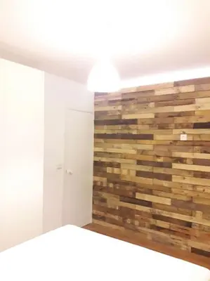 a room with a wall made of wood at HABITACIÓN DOBLE, near train, bus that goes to Barcelona in Manresa