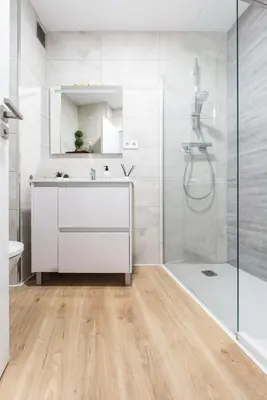 a bathroom with a white vanity and a shower at Apartamento Granollers in Granollers