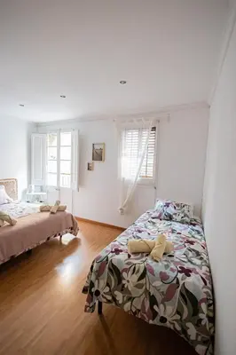 a bedroom with two beds and a window at 2 bedroom apartment Barcelona Center in Barcelona