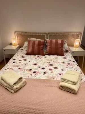 a bed with two pillows and towels on it at 2 bedroom apartment Barcelona Center in Barcelona