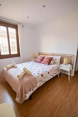 a bedroom with a large bed with pink pillows at 2 bedroom apartment Barcelona Center in Barcelona