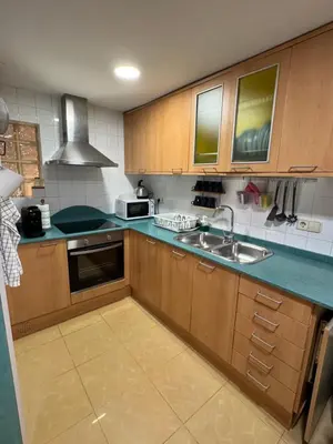 a kitchen with wooden cabinets and a sink at 2 bedroom apartment Barcelona Center in Barcelona
