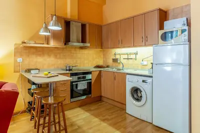 a kitchen with a white refrigerator and a washer at 4179 - AB Verdi Villa de Gracia Apartment in Barcelona