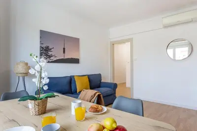 a living room with a table and a blue couch at 4254 - AB Sagrada Familia Views III-II in Barcelona
