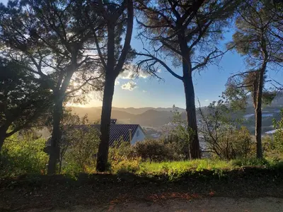 a cloudy sky with trees in the distance at Can Loïs in Sant Cebrià de Vallalta