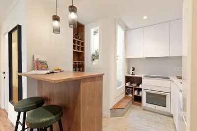 a kitchen with a counter and some stools in it at Enjoy Apartments La Riera Principal in Barcelona