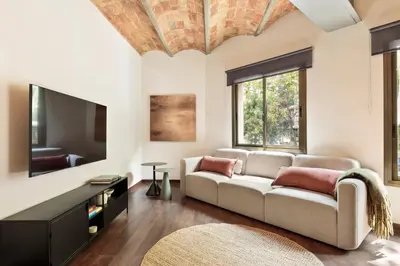 a living room with a couch and a flat screen tv at Enjoy Apartments Urban Retreat Valencia 4 in Barcelona