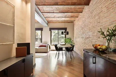 a kitchen and dining room with a brick wall at Enjoy Apartments Urban Retreat Valencia 4 in Barcelona