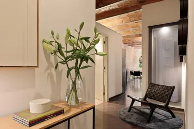 a vase with a plant on a table in a room at Enjoy Apartments Urban Retreat Valencia 1 in Barcelona
