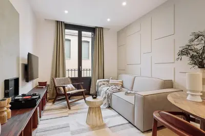 a living room with a couch and a tv at Pompei - 2 bedrooms, balcony and terrace in Ciutat Vella in Barcelona
