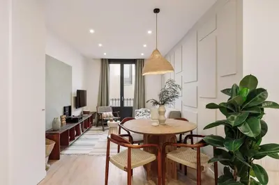 a living room with a table and a couch at Pompei - 2 bedrooms, balcony and terrace in Ciutat Vella in Barcelona