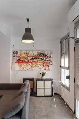 a living room with a couch and a painting on the wall at Full 50sqm Loft in Badalona in Badalona