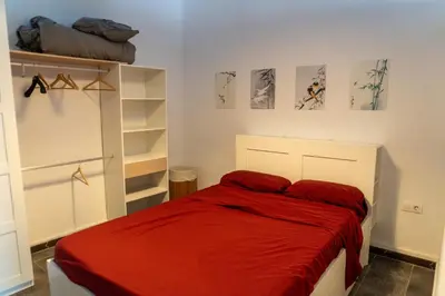 a bedroom with a bed with a red blanket at Full 50sqm Loft in Badalona in Badalona