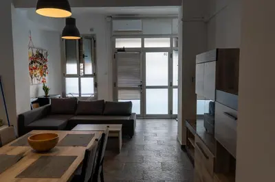 a living room with a couch and a table at Full 50sqm Loft in Badalona in Badalona