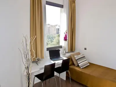 a bedroom with a desk with a laptop computer on it at Flat with views to Sagrada Famila in Barcelona