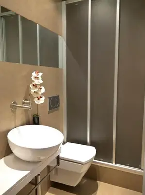 a bathroom with a toilet and a sink and a shower at Flat with views to Sagrada Famila in Barcelona