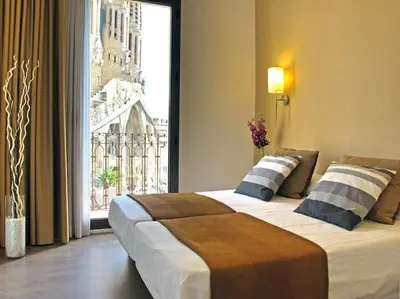 a hotel room with a large bed and a large window at Flat with views to Sagrada Famila in Barcelona
