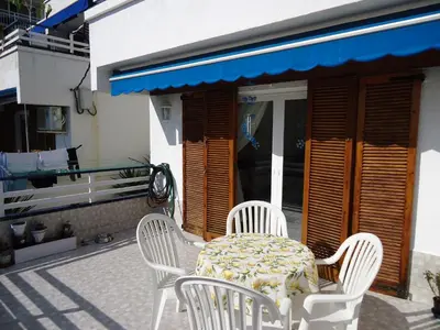 a table and chairs sitting on a patio at brisa mar in San Pol de Mar