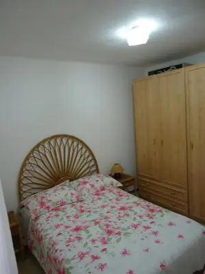 a bedroom with a bed with a floral bedspread at brisa mar in San Pol de Mar