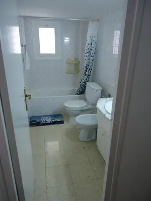 a white bathroom with a toilet and a sink at brisa mar in San Pol de Mar