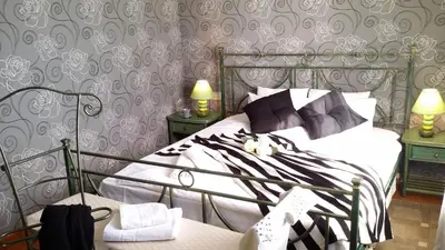 a bedroom with a bed with black and white pillows at Carmen Seaview & Beach - Apartment in Montgat