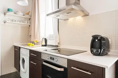 a kitchen with a stove top oven next to a sink at Lodging Apartments Almirall Beach 52 in Barcelona