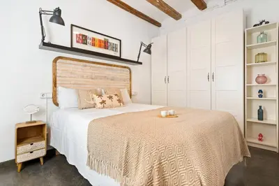 a white bedroom with a large bed and white cabinets at Lodging Apartments Almirall Beach 52 in Barcelona