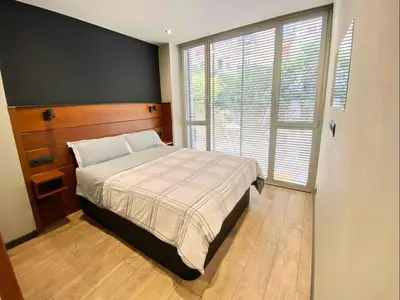 a bedroom with a bed and a large window at Gaudi Comfort in Barcelona
